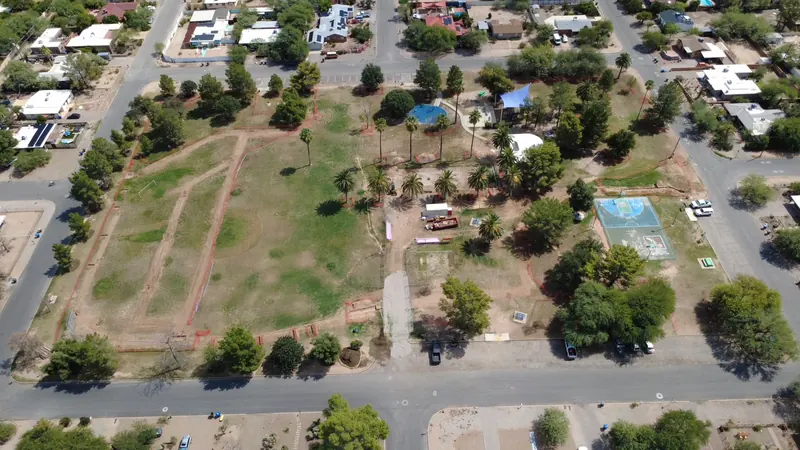 Aerial view of irrigation trench routes cut across park turf
