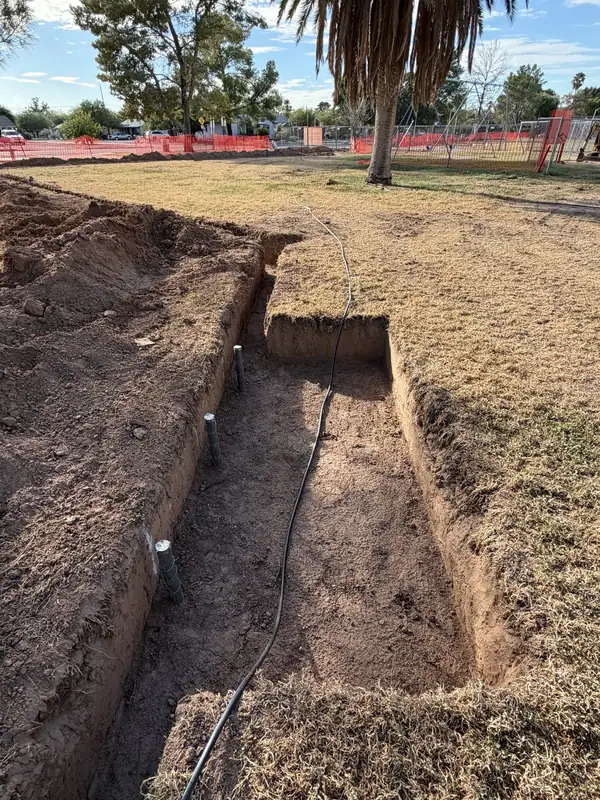 Irrigation pipe laid at a junction in an open trench