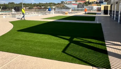 Turf field with a crew member working on the edge