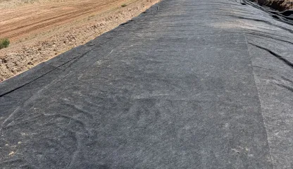 Geotextile lining along a channel
